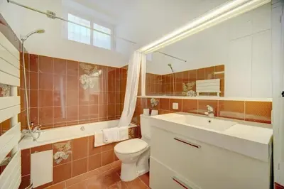 a bathroom with a toilet and a sink and a mirror at Villa Luna Nova in Cannes