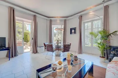 a living room with a glass table and chairs at Villa Luna Nova in Cannes