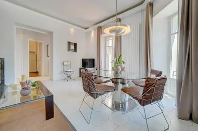 a living room with a glass table and chairs at Villa Luna Nova in Cannes