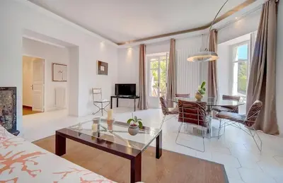 a living room with a table and a couch at Villa Luna Nova in Cannes
