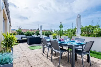 a patio with a table and chairs on a patio at RARE! 120m ROOFTOP 5-minute walk to downtown in Cannes