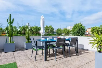a table and chairs on a patio with an umbrella at RARE! 120m ROOFTOP 5-minute walk to downtown in Cannes