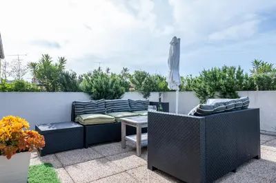 a patio with a couch and a table and an umbrella at RARE! 120m ROOFTOP 5-minute walk to downtown in Cannes