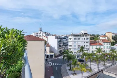 a view of a city with palm trees and buildings at RARE! 120m ROOFTOP 5-minute walk to downtown in Cannes