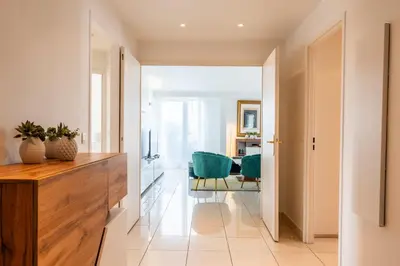 a hallway with a desk and two green chairs at RARE! 120m ROOFTOP 5-minute walk to downtown in Cannes