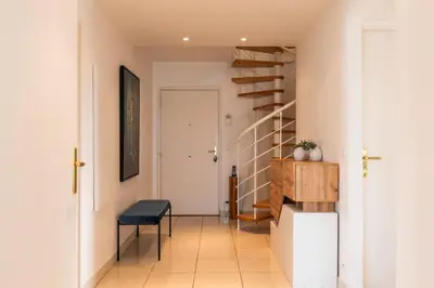 a hallway with a staircase and a stool in a house at RARE! 120m ROOFTOP 5-minute walk to downtown in Cannes