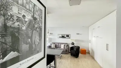 a living room with a couch and a table at 2 Room modern, terrace and Parking in Cannes