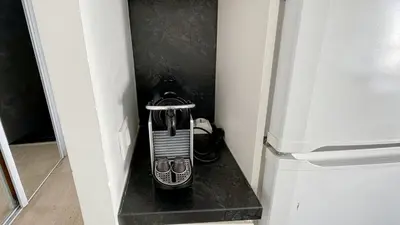 a room with two beds and a television in it at 2 Room modern, terrace and Parking in Cannes