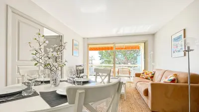 a living room with a table and a couch at Deluxe 2 bedroom apartment in Cannes