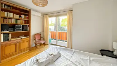 a bedroom with a bed and a book shelf at Deluxe 2 bedroom apartment in Cannes