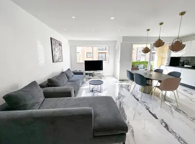 a living room with a couch and a table at Modern 3 bedroom flat with balcony in Cannes