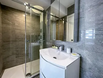 a bathroom with a sink and a shower at Modern 3 bedroom flat with balcony in Cannes