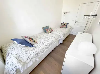 a bedroom with two beds with pillows at Beautifully renovated 3 bedroom apartment in the heart of Cannes in Cannes