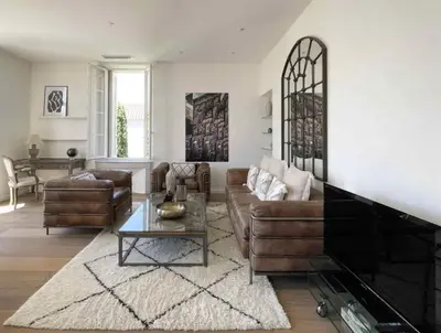 a living room with a couch and a table at Beautifully renovated 3 bedroom apartment in the heart of Cannes in Cannes
