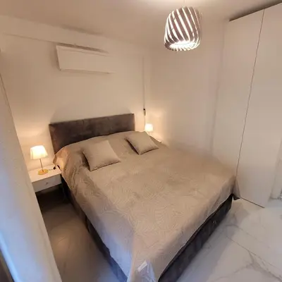 a bedroom with a large bed and a pendant light at Bell Appartement Cannes in Cannes