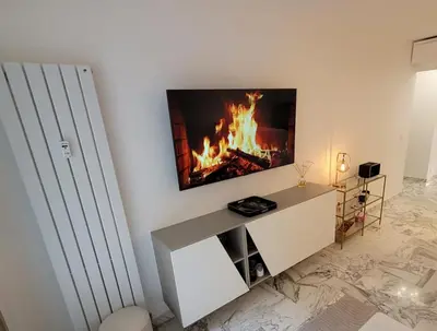 a living room with a fire in the wall at Bell Appartement Cannes in Cannes