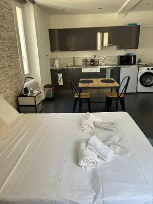 a bedroom with a white bed with towels on it at Les Suisses Apartment Zentral in der schönen Altstadt von Le Suquet 5 min zum Strand WLAN in Cannes