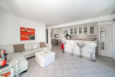 a living room with a couch and a kitchen at Pleasant 2 bedroom close to the center of Cannes in Cannes