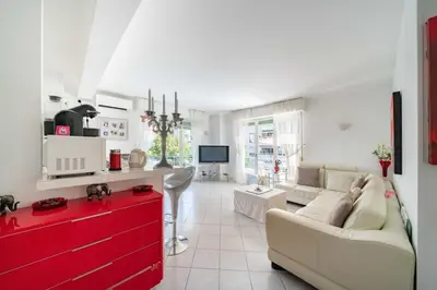 a living room with a couch and a red dresser at Pleasant 2 bedroom close to the center of Cannes in Cannes