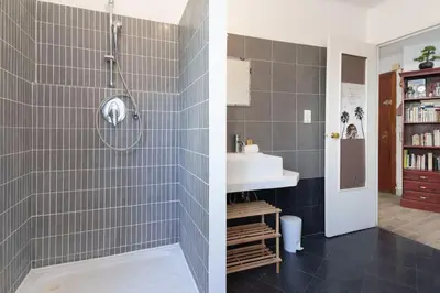 two pictures of a bathroom with a shower and a sink at Le Sorbier By ApiRent #Wifi #Climatisation #Lumineux in Cannes