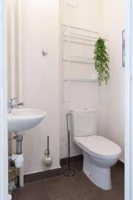 a bathroom with a white toilet and a sink at Le Sorbier By ApiRent #Wifi #Climatisation #Lumineux in Cannes