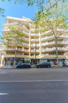 two cars parked in front of a large building at Le Sorbier By ApiRent #Wifi #Climatisation #Lumineux in Cannes