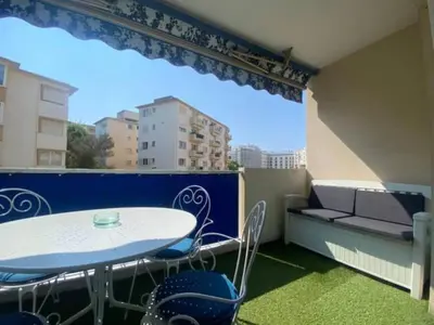 a balcony with a table and chairs and a window at C029-Appartement spacieux a deux pas de la Croisette in Cannes
