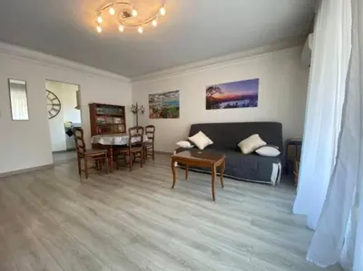 a living room with a couch and a table at C029-Appartement spacieux a deux pas de la Croisette in Cannes