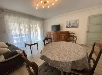 a living room with a table and a couch at C029-Appartement spacieux a deux pas de la Croisette in Cannes