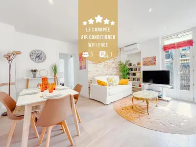 a living room with a table and a couch at Le canopée - Cozy Suquet Cannes Centre in Cannes