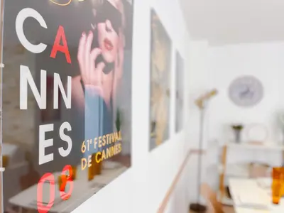 a poster on a wall in a room with a staircase at Le canopée - Cozy Suquet Cannes Centre in Cannes