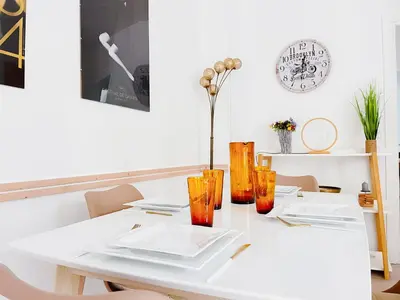 a white table with orange vases on it at Le canopée - Cozy Suquet Cannes Centre in Cannes