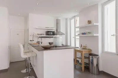 a white kitchen with a counter and a sink at 