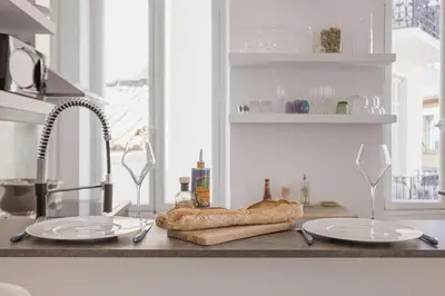 a kitchen counter with two plates and a loaf of bread at 