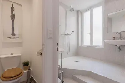 a bathroom with a shower and a toilet and a sink at 