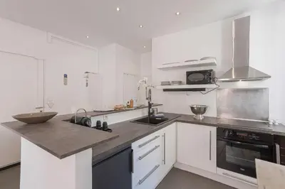 a white kitchen with a sink and a stove at 