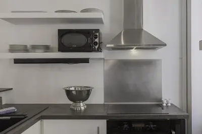 a kitchen with a stove top oven and a microwave at 