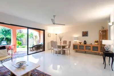 a living room with a table and a dining room at villa dans résidence à Cannes in Cannes