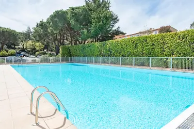 a swimming pool with a fence around it at villa dans résidence à Cannes in Cannes