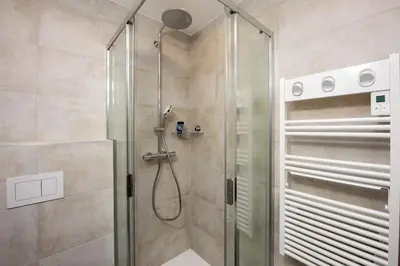 a shower with a glass door in a bathroom at Appartement Dollia - Welkeys in Cannes