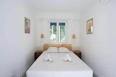 a bedroom with a white bed with two pillows at Appartement Dollia - Welkeys in Cannes