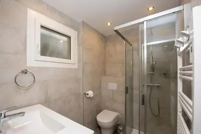 a bathroom with a shower and a toilet and a sink at Appartement Dollia - Welkeys in Cannes