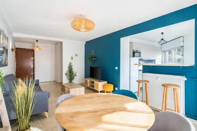 a living room with a table and chairs at Nice one bedroom in the heart of Cannes in Cannes