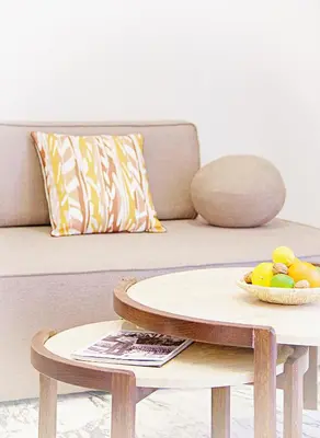 a coffee table with a bowl of fruit on a couch at Le charme de Cannes in Cannes