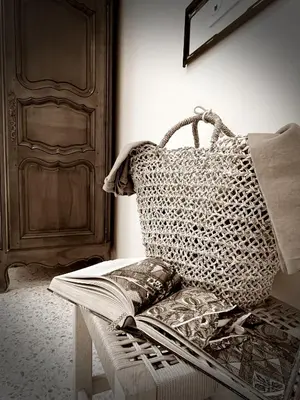 a room with a bed with a book and a door at Le charme de Cannes in Cannes