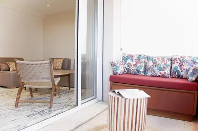 a living room with a couch and a chair at Le charme de Cannes in Cannes
