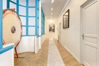 a hallway with blue and white walls and a door at Le Palais Beausite - Palais à Cannes in Cannes