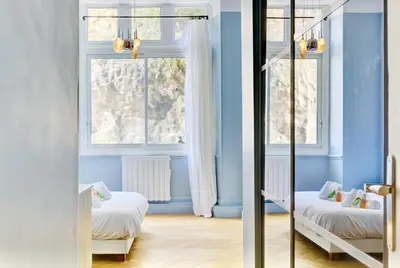 a room with two beds and a window at Le Palais Beausite - Palais à Cannes in Cannes
