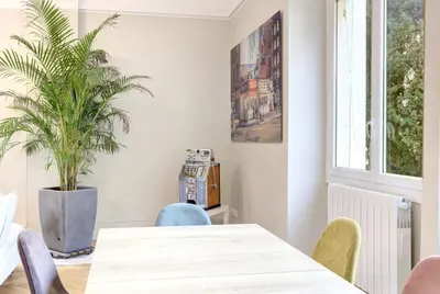 a dining room with a table and a potted plant at Le Palais Beausite - Palais à Cannes in Cannes