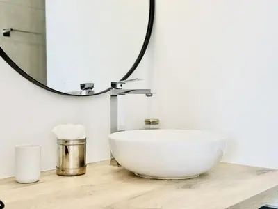 a bathroom with a bowl sink and a mirror at L'impérator - Petit Juas Cannes in Cannes